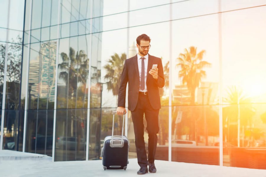 Elegant businessman checking mobile phone