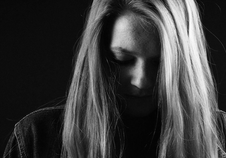 Sad girl in black background